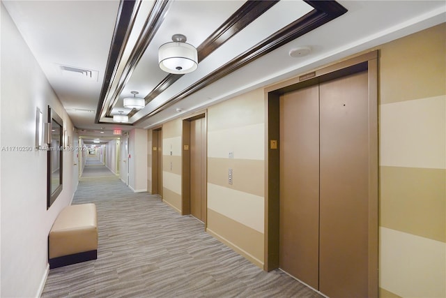 corridor featuring elevator and light carpet