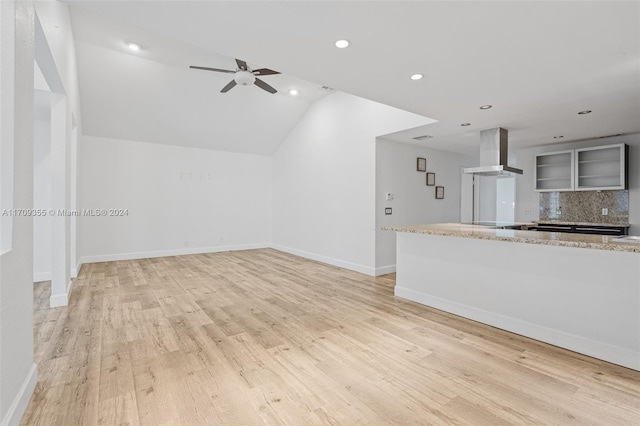 unfurnished living room with ceiling fan, lofted ceiling, and light wood-type flooring