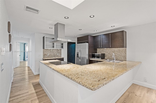 kitchen with sink, dark brown cabinetry, island range hood, kitchen peninsula, and stainless steel appliances