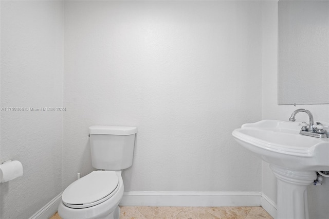 bathroom featuring tile patterned flooring and toilet