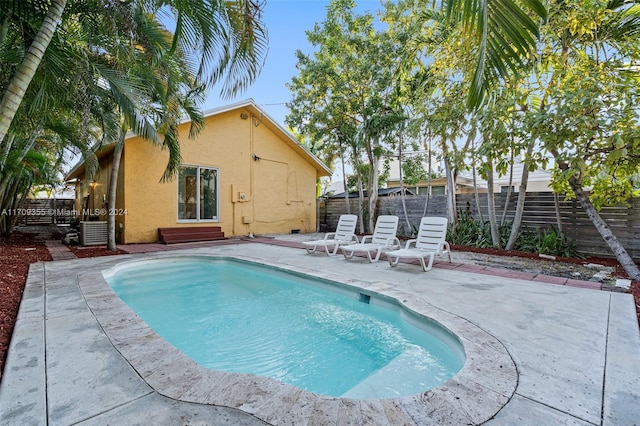 view of swimming pool featuring a patio and central AC unit