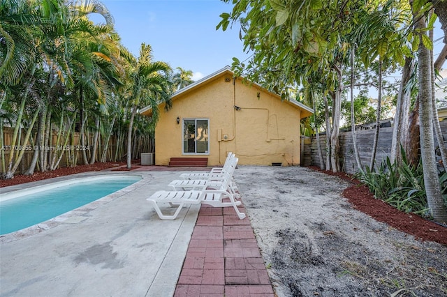 view of swimming pool featuring central AC and a patio