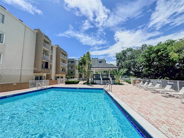 view of swimming pool featuring a gazebo and a patio