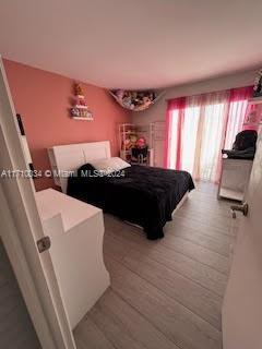 bedroom with wood-type flooring