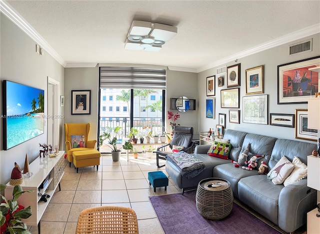 living area with crown molding, visible vents, light tile patterned flooring, ceiling fan, and a textured ceiling