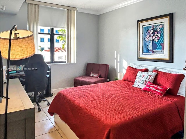 bedroom with light tile patterned floors, visible vents, and crown molding