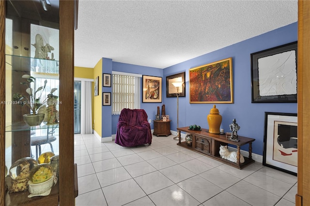 sitting room with light tile patterned floors and a textured ceiling