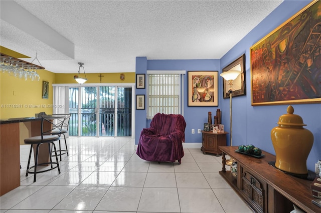 living room featuring light tile patterned flooring and a textured ceiling