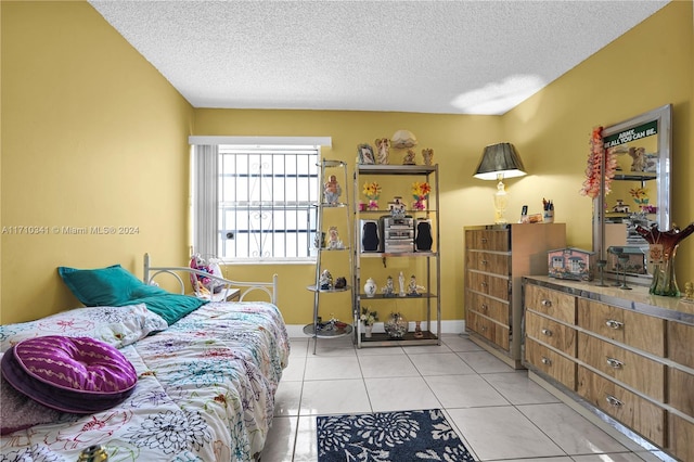 tiled bedroom featuring a textured ceiling