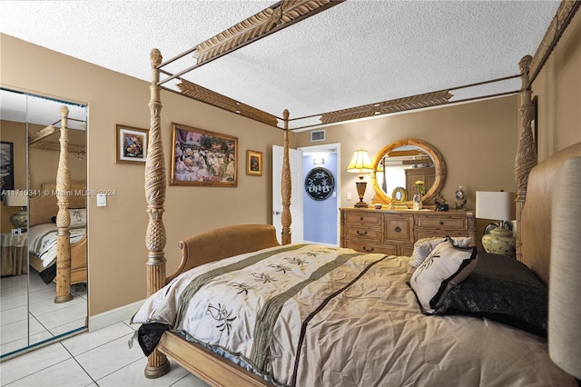 tiled bedroom featuring a textured ceiling