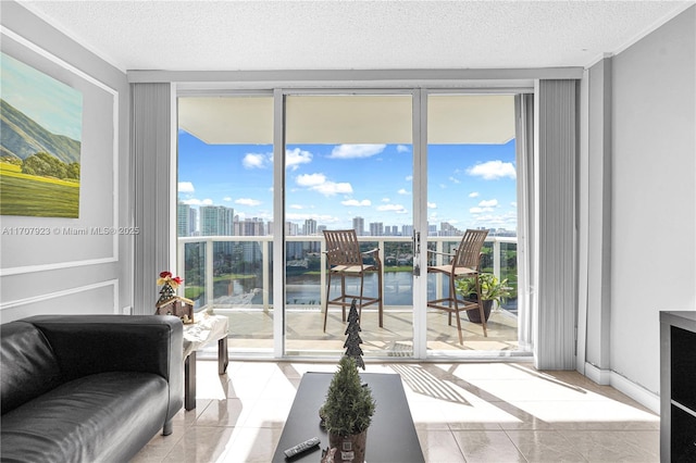 tiled living room with a water view, plenty of natural light, expansive windows, and a textured ceiling