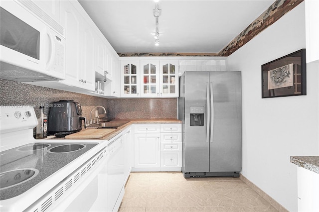 kitchen featuring tasteful backsplash, sink, white appliances, and white cabinets