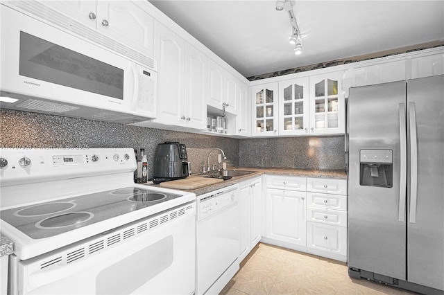 kitchen with tasteful backsplash, white cabinetry, sink, and white appliances