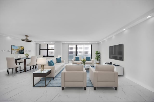 living room with plenty of natural light and ceiling fan