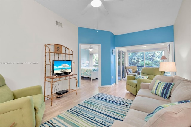 living room featuring ceiling fan and light wood-type flooring