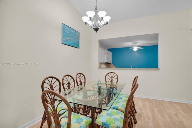 dining space featuring ceiling fan with notable chandelier and light hardwood / wood-style floors