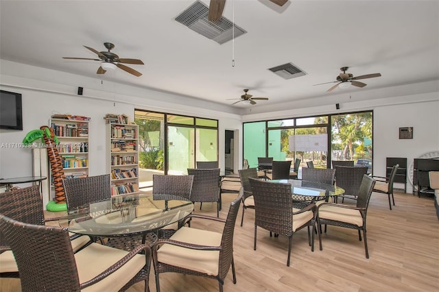 dining room with ceiling fan and light wood-type flooring