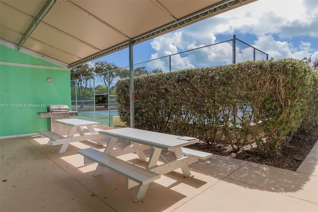 view of patio / terrace with tennis court and area for grilling