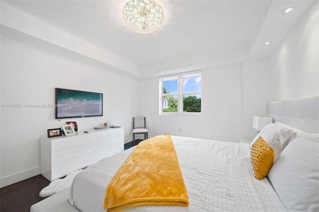 bedroom with dark hardwood / wood-style floors