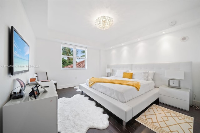 bedroom with dark hardwood / wood-style floors