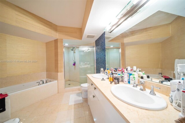 full bathroom featuring tile patterned flooring, vanity, independent shower and bath, and toilet