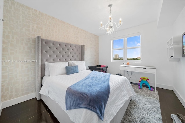 bedroom with a chandelier and dark wood-type flooring