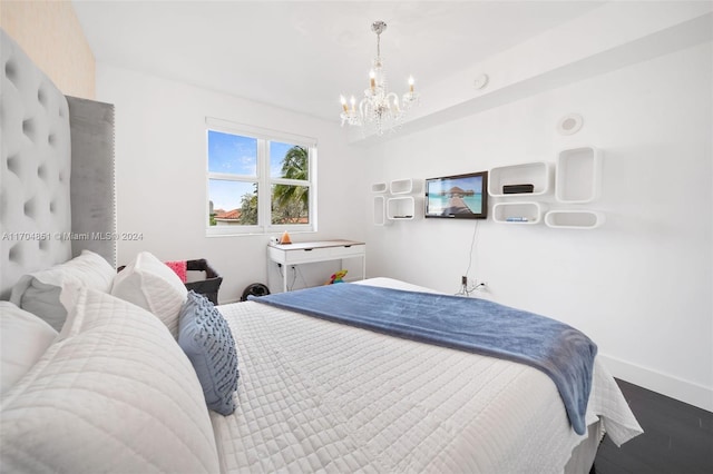 bedroom featuring a chandelier and hardwood / wood-style flooring