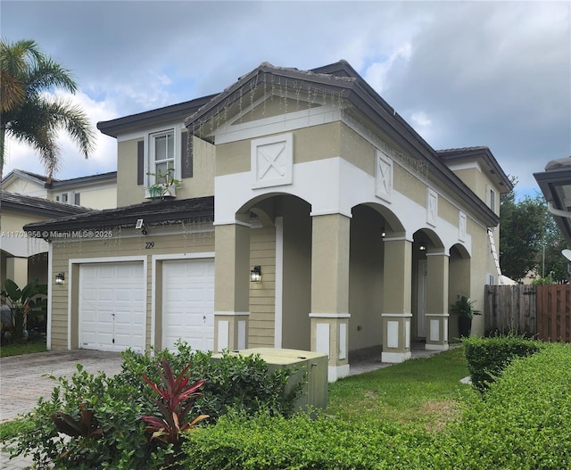229 NE 36th Ter, Homestead, FL 33033 - view of front facade featuring a garage, stucco siding, and driveway