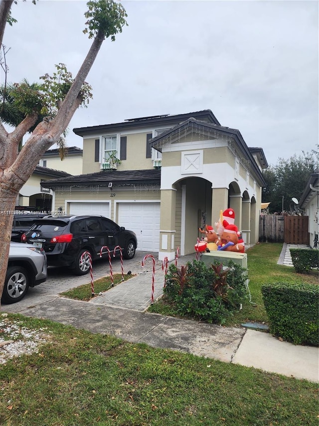 view of front of house featuring a front yard and a garage