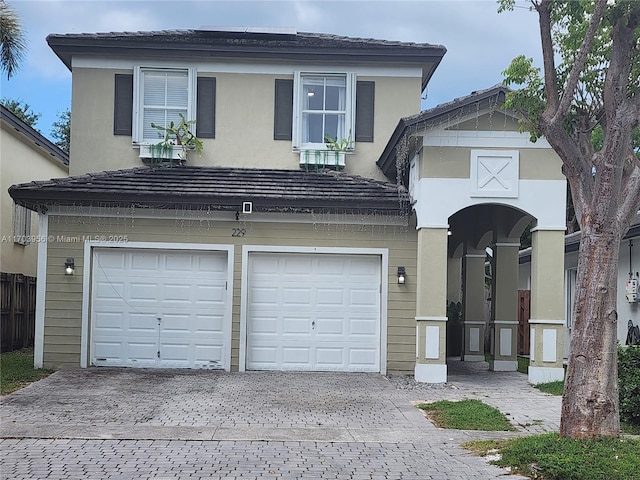 229 NE 36th Ter, Homestead, FL 33033 - traditional-style house with an attached garage, decorative driveway, and stucco siding