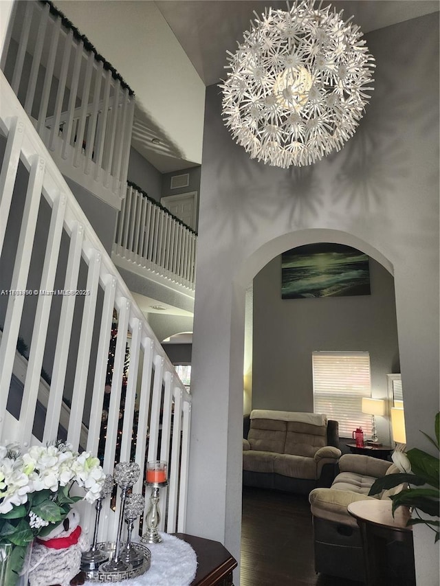 229 NE 36th Ter, Homestead, FL 33033 - stairway with arched walkways, a high ceiling, wood finished floors, and a chandelier