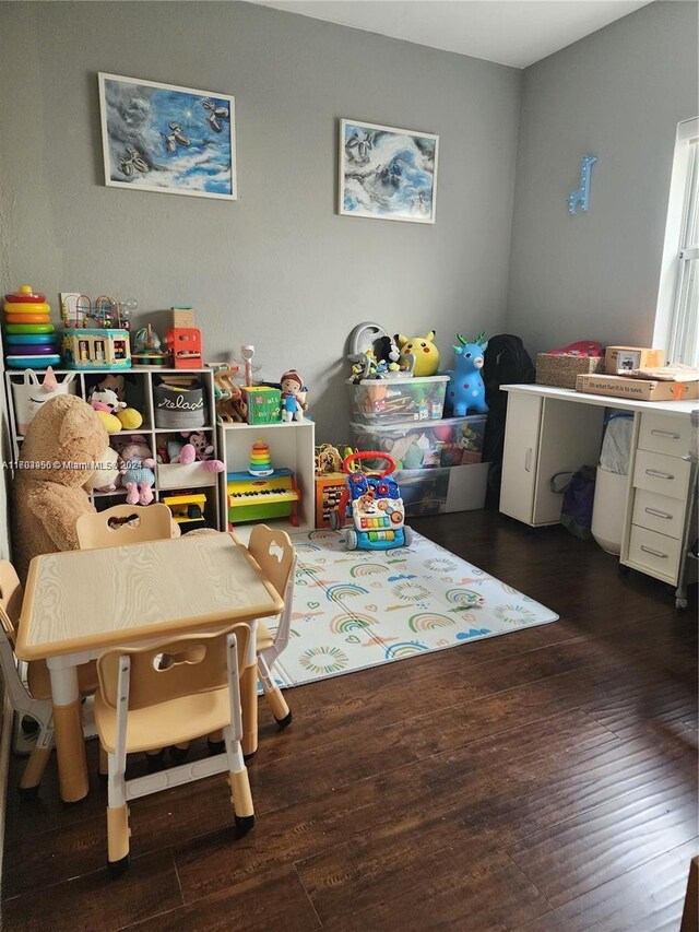 game room with dark hardwood / wood-style flooring