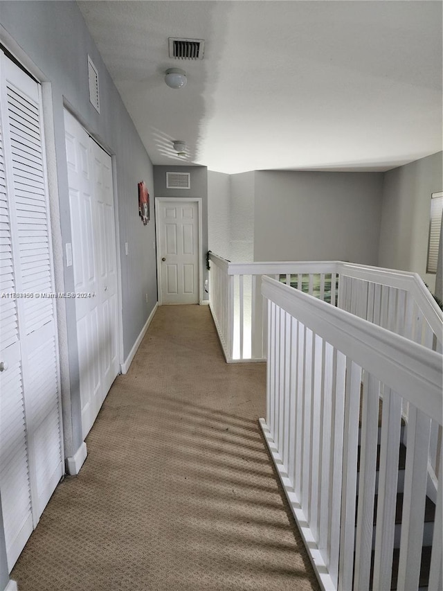 hallway with carpet flooring