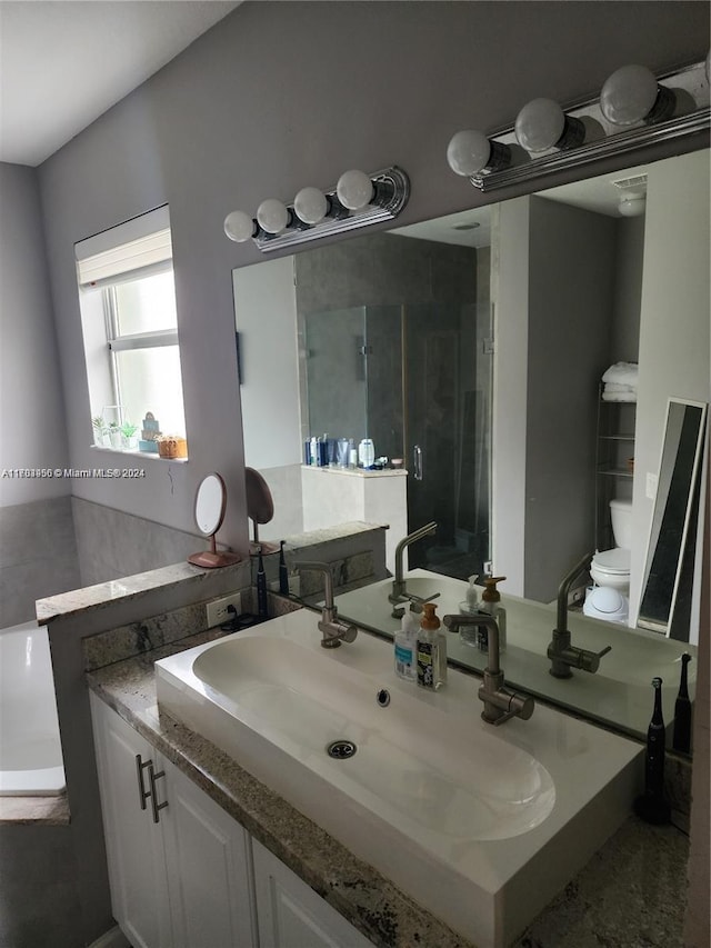 bathroom featuring vanity and a shower with shower door