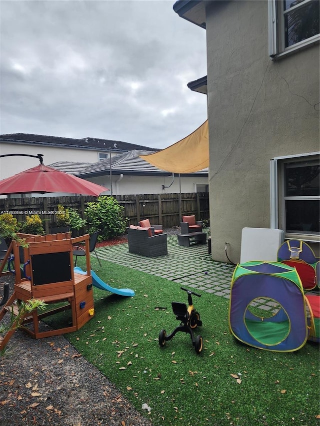 view of playground with a patio