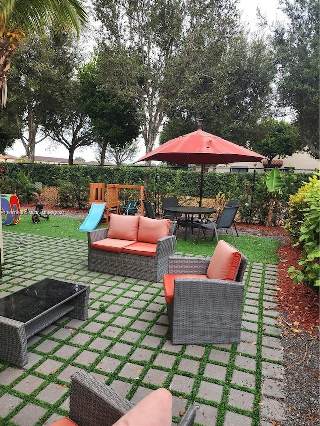 view of patio with a playground and an outdoor living space