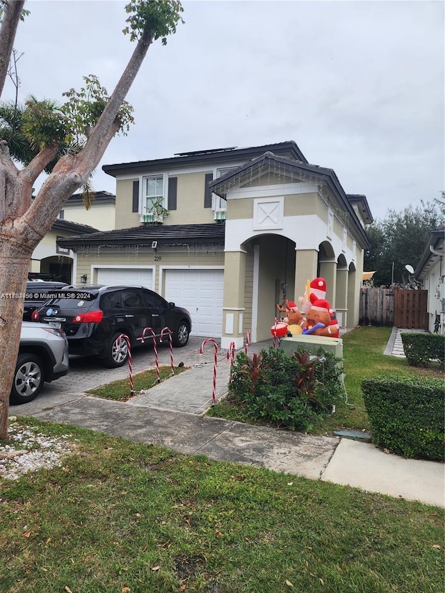 view of front of home with a front yard and a garage