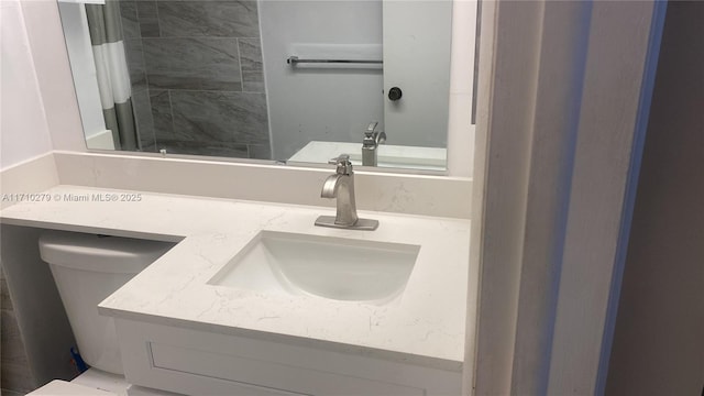 bathroom with a shower, vanity, and toilet