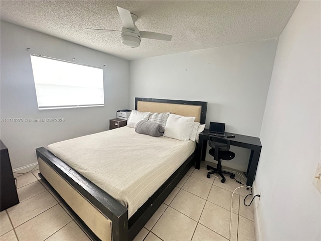 tiled bedroom featuring ceiling fan and a textured ceiling