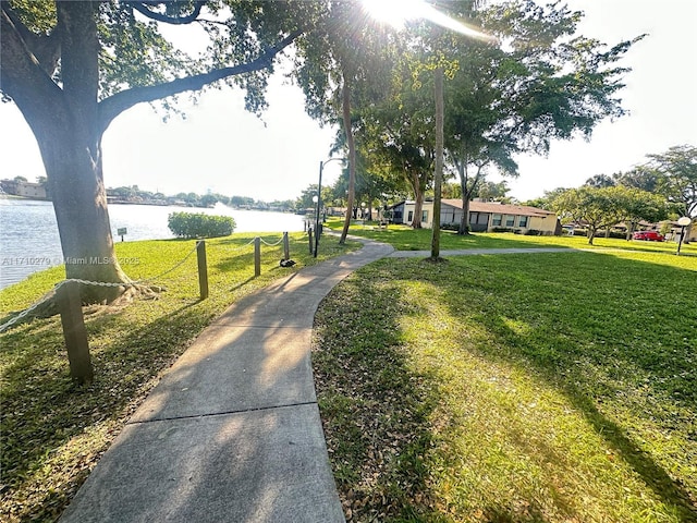 view of community with a yard and a water view