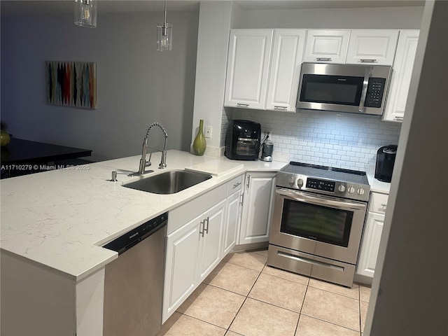 kitchen with white cabinetry, kitchen peninsula, and appliances with stainless steel finishes