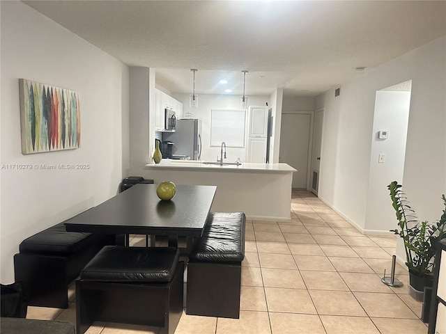 tiled dining room featuring sink