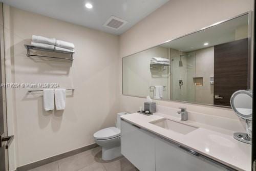 bathroom featuring tile patterned floors, an enclosed shower, vanity, radiator heating unit, and toilet