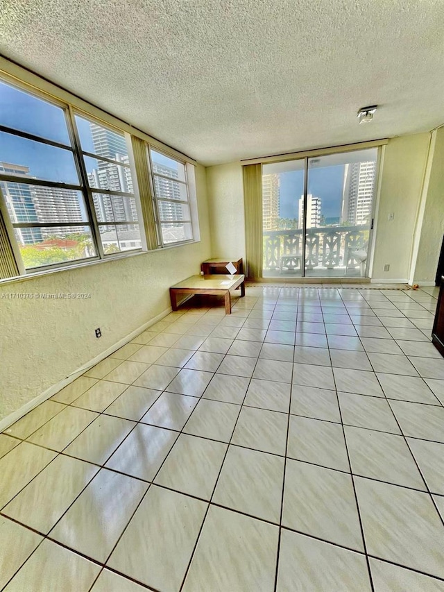 interior space featuring light tile patterned floors and a textured ceiling