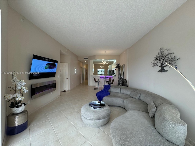 tiled living room featuring a textured ceiling