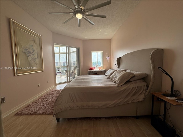 bedroom with access to outside, ceiling fan, a textured ceiling, and hardwood / wood-style flooring