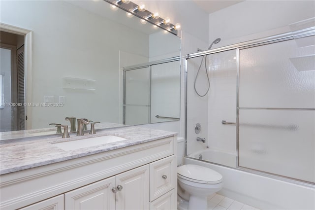 full bathroom with tile patterned flooring, vanity, toilet, and bath / shower combo with glass door