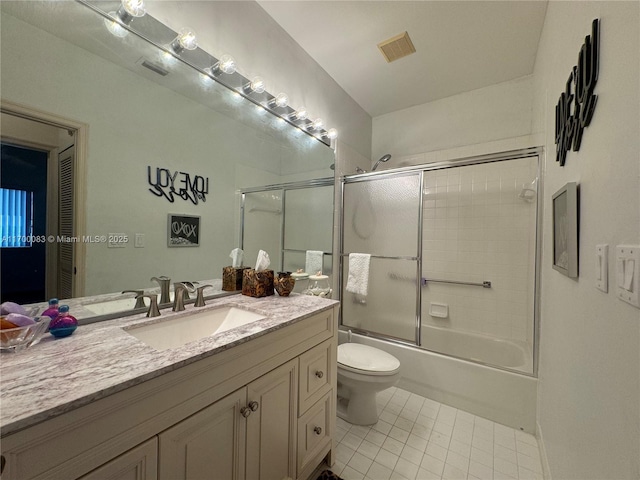 full bathroom featuring tile patterned flooring, vanity, toilet, and enclosed tub / shower combo