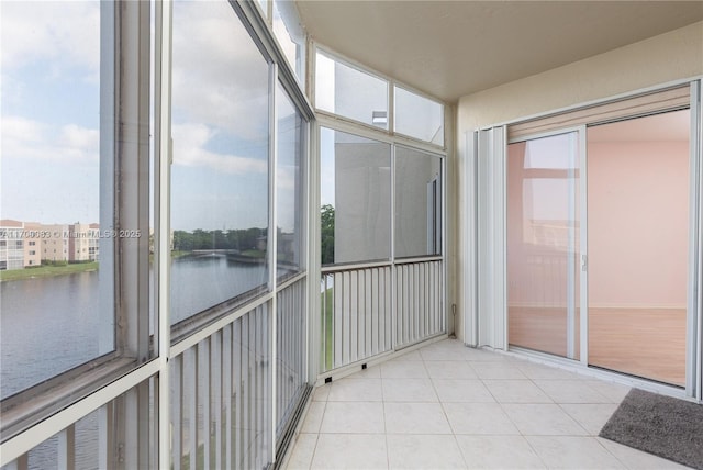 unfurnished sunroom featuring a water view and a wealth of natural light