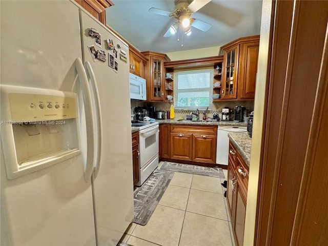 kitchen featuring ceiling fan, sink, tasteful backsplash, white appliances, and light tile patterned floors